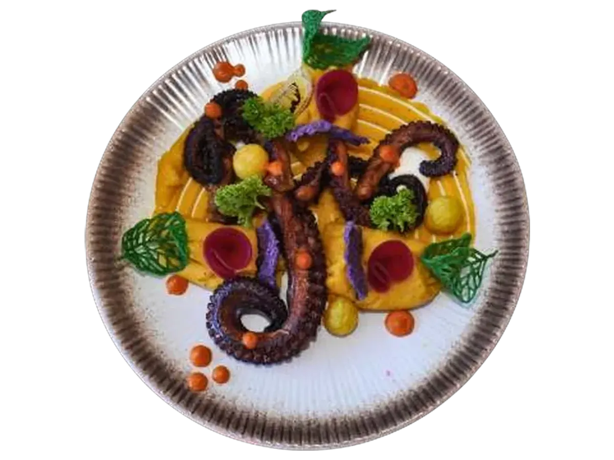 Grilled octopus tentacles over saffron purée with purple chips and beetroot.